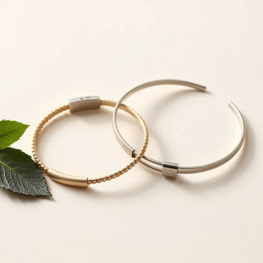 Two matching couple bracelets lying side by side on a light neutral background.
